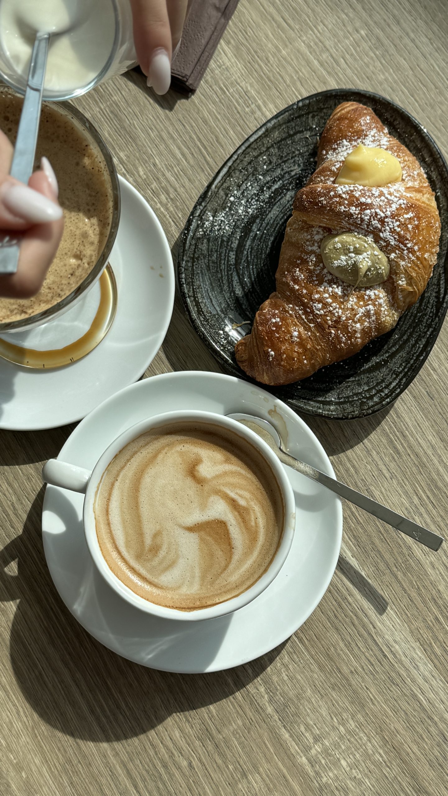 Cappuccino and filled pastries arranged on a café table in Piedmont.
