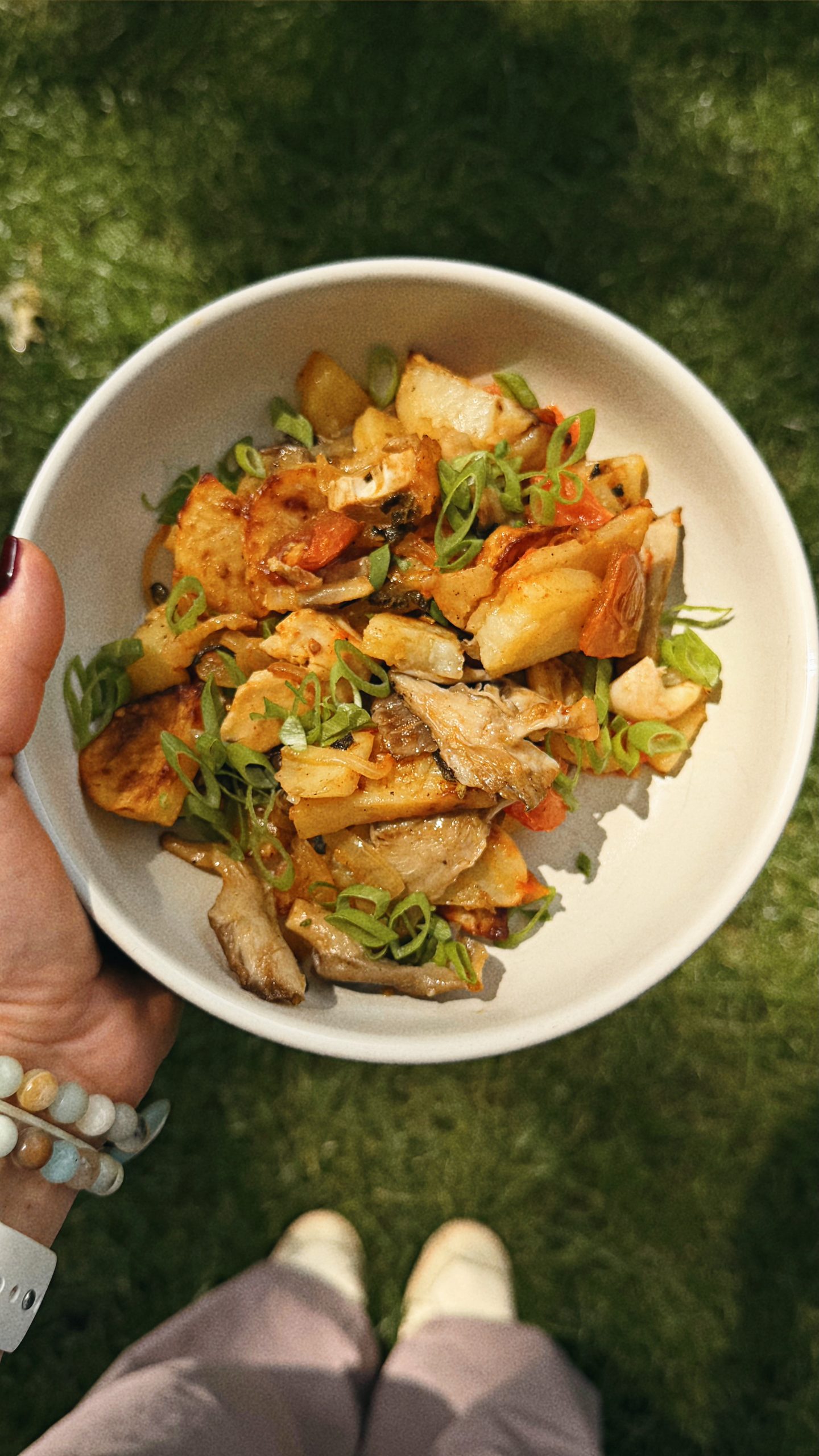 Breakfast bowl of roasted potatoes, caramelized onions, oyster mushrooms, chicken, tomatoes, garlic, and sage.