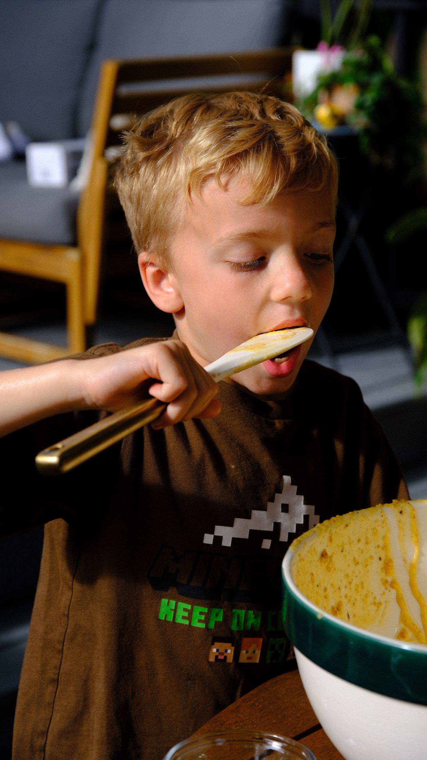 Christopher tasting hazelnut cake batter from the spatula.
