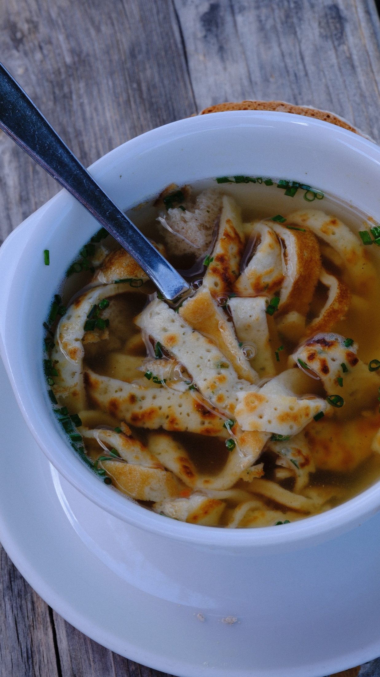 A bowl of Flädlesuppe with fine pancake ribbons at Restaurant Feineck