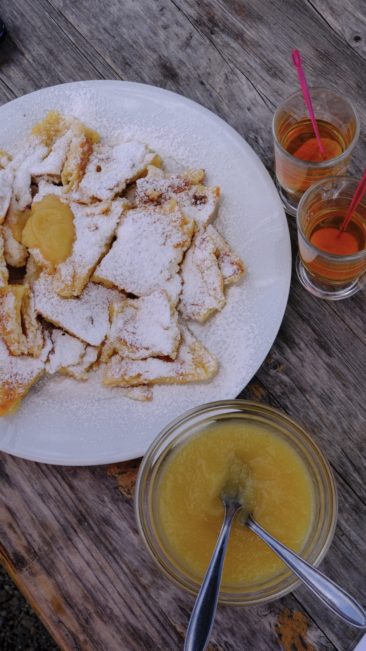 Kaiserschmarrn dusted with sugar and served with Apfelmus