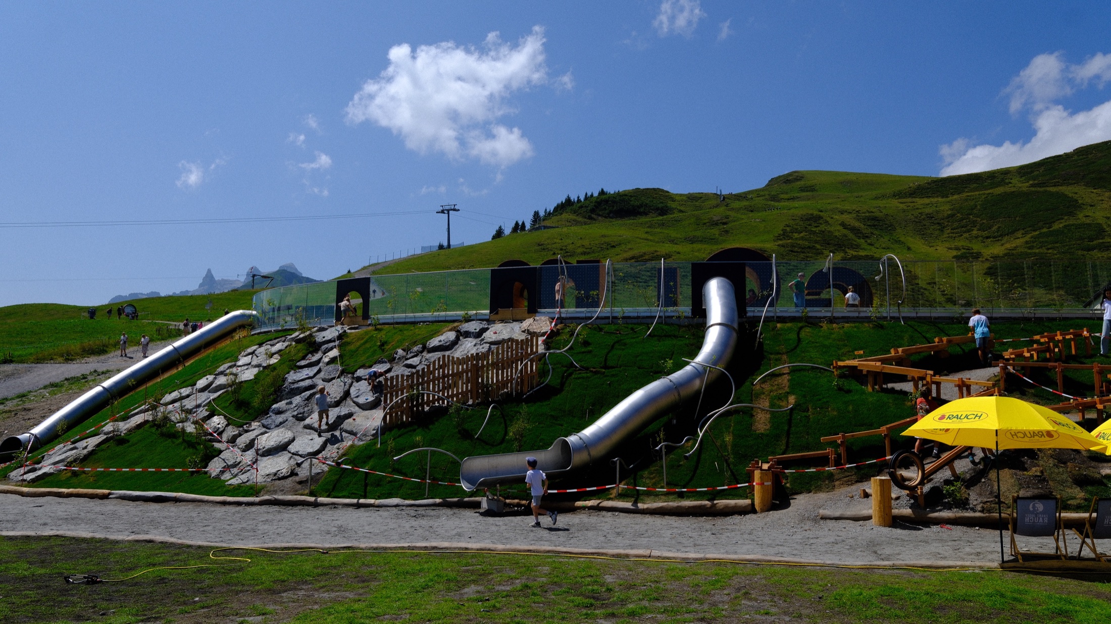 Outdoor activity structures and a slide in the high meadow at Grüneck on Golm mountain