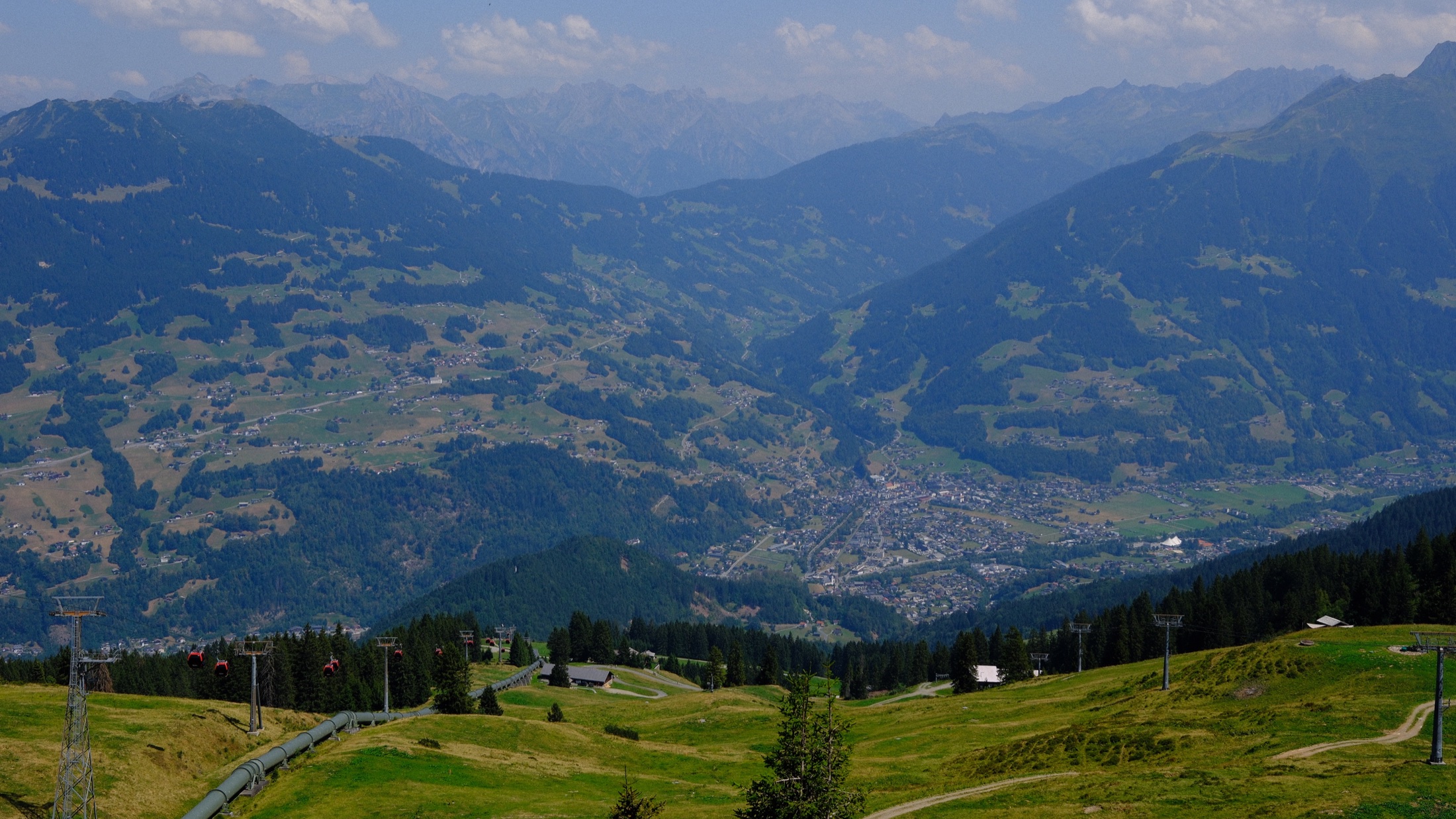 A wide view across the green Montafon valley from Golm