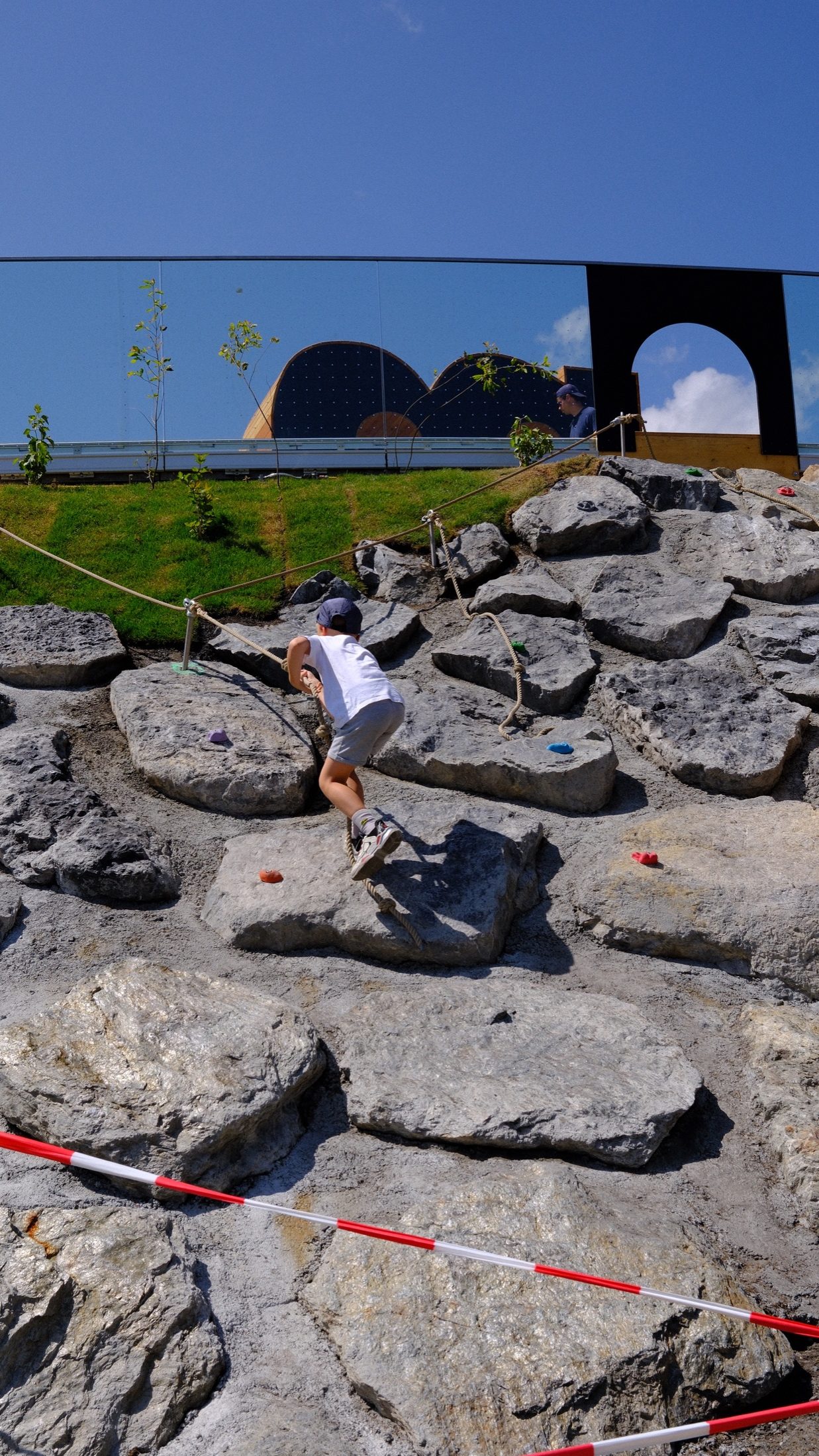 Bird figures and climbing rocks in an outdoor activity area at Golm