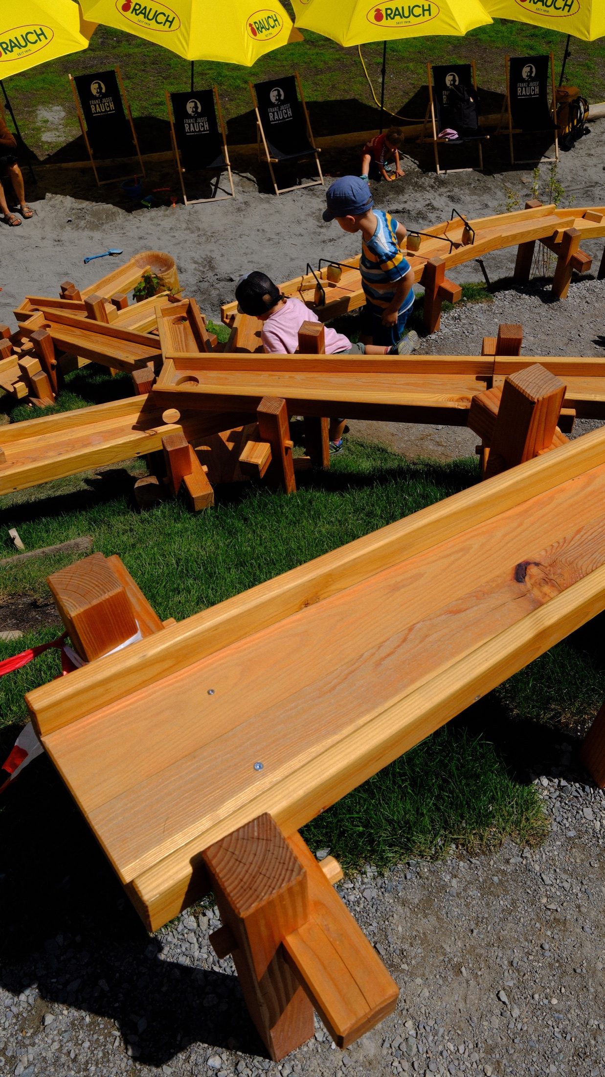 A child exploring a carved wooden activity station at Golm
