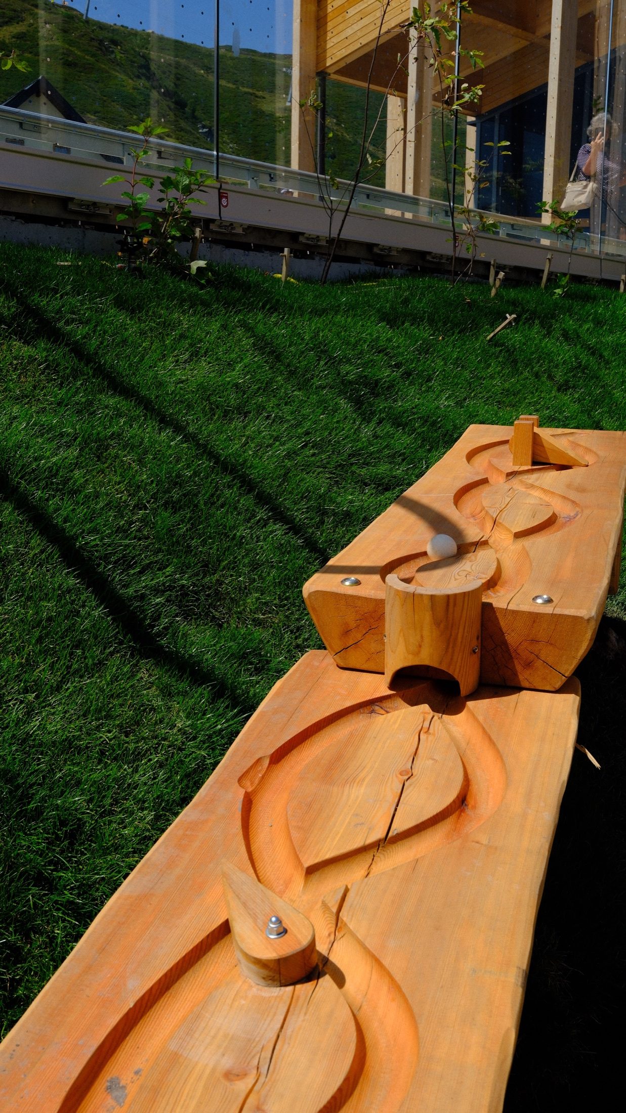 Hands trying one of the wooden activity challenges at Grüneck