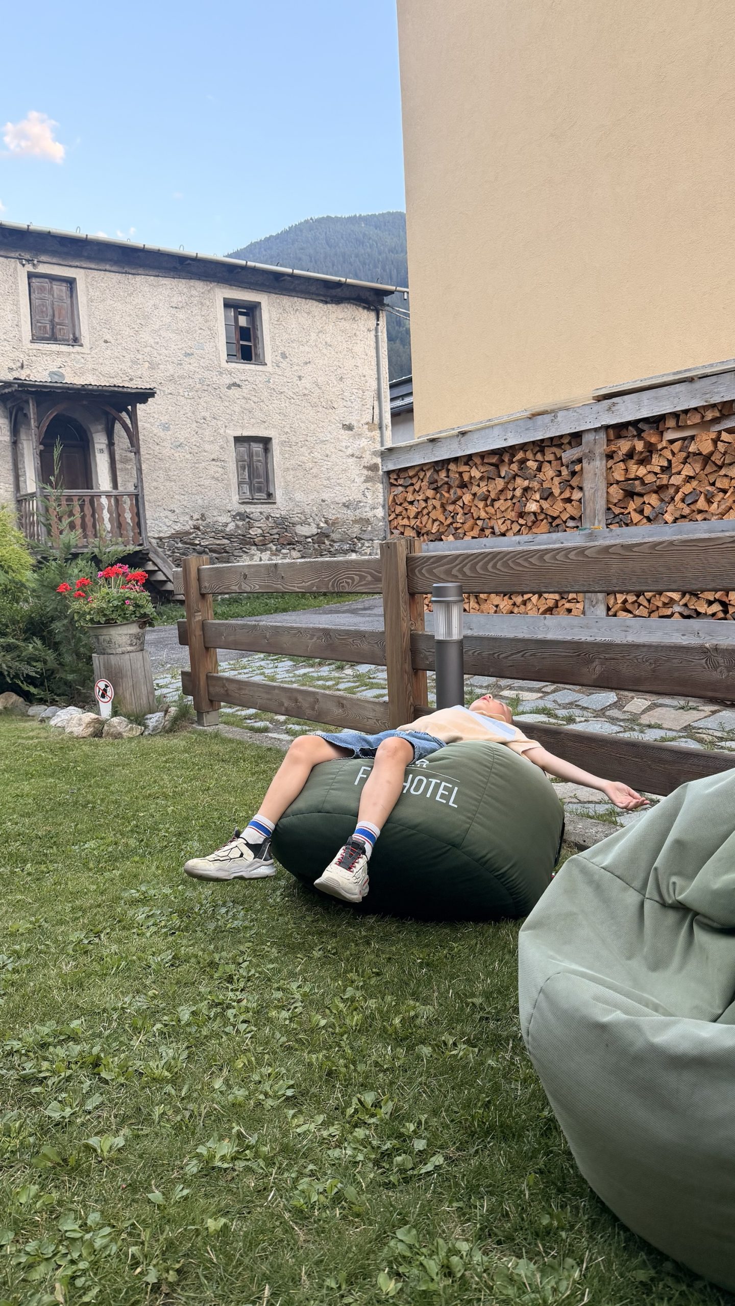 Chris resting on a green garden cushion at Alpen Hotel