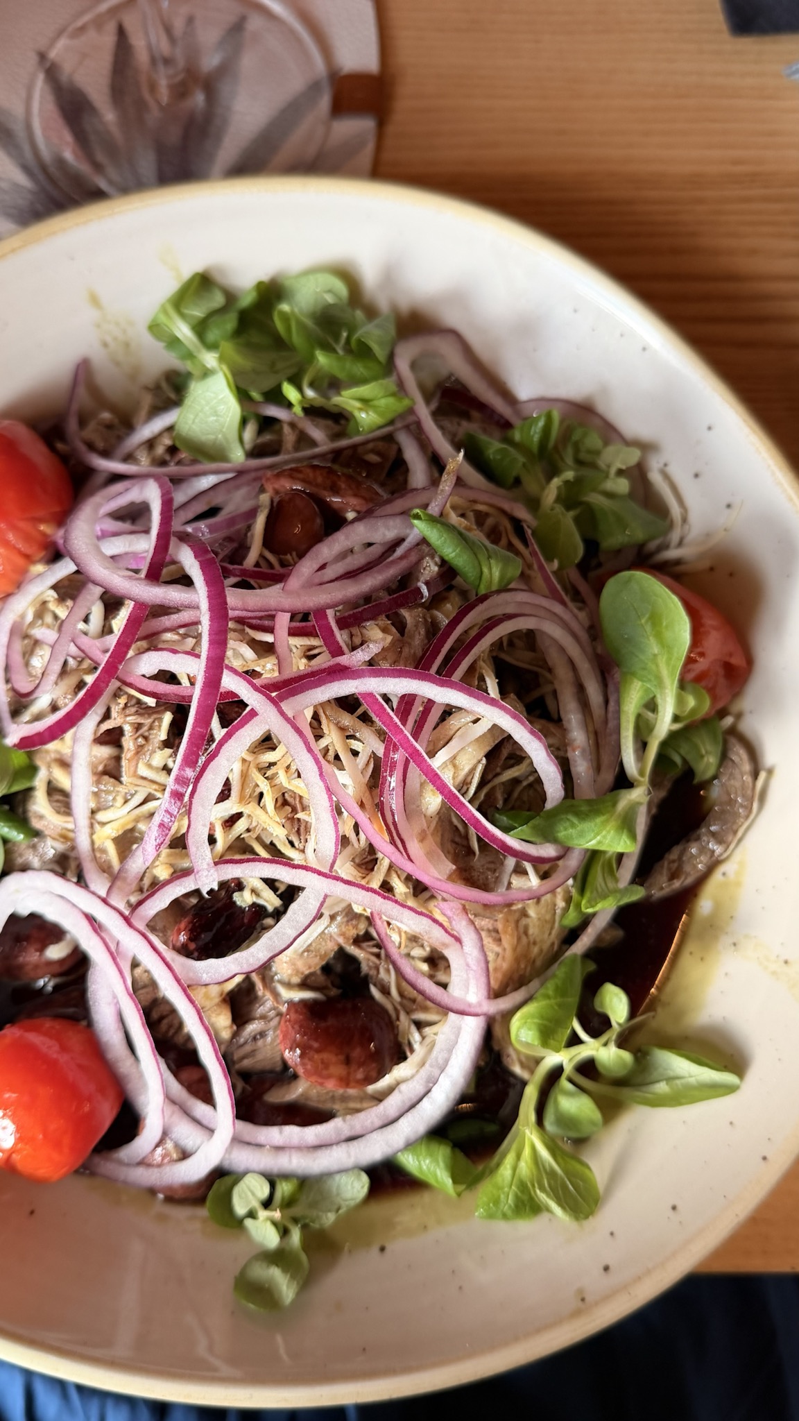 Original boiled beef salad served in Schruns with red onion, runner beans, grated horseradish, tomatoes, lamb’s lettuce, and a generous pool of pumpkin seed oil dressing
