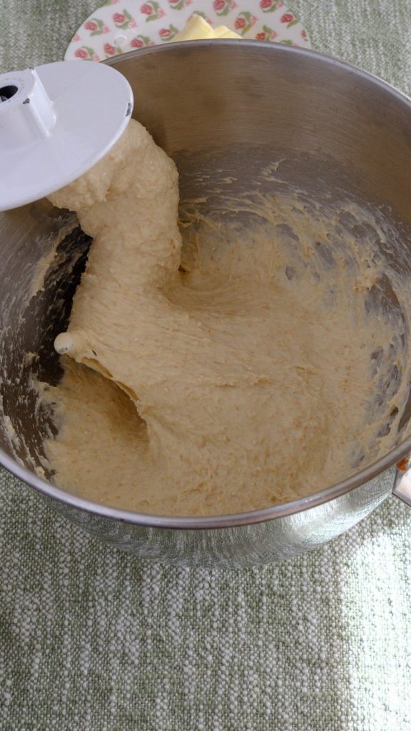 Soft oat bran bread dough mixing around a stand mixer dough hook